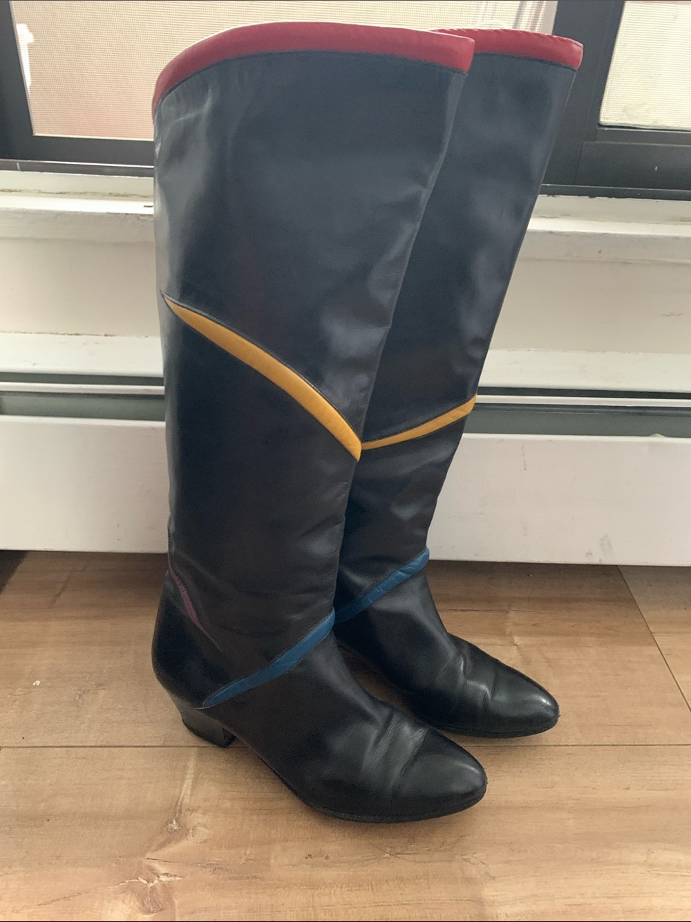 Black Leather Knee-High Boots with Red Trim and Color Accents
